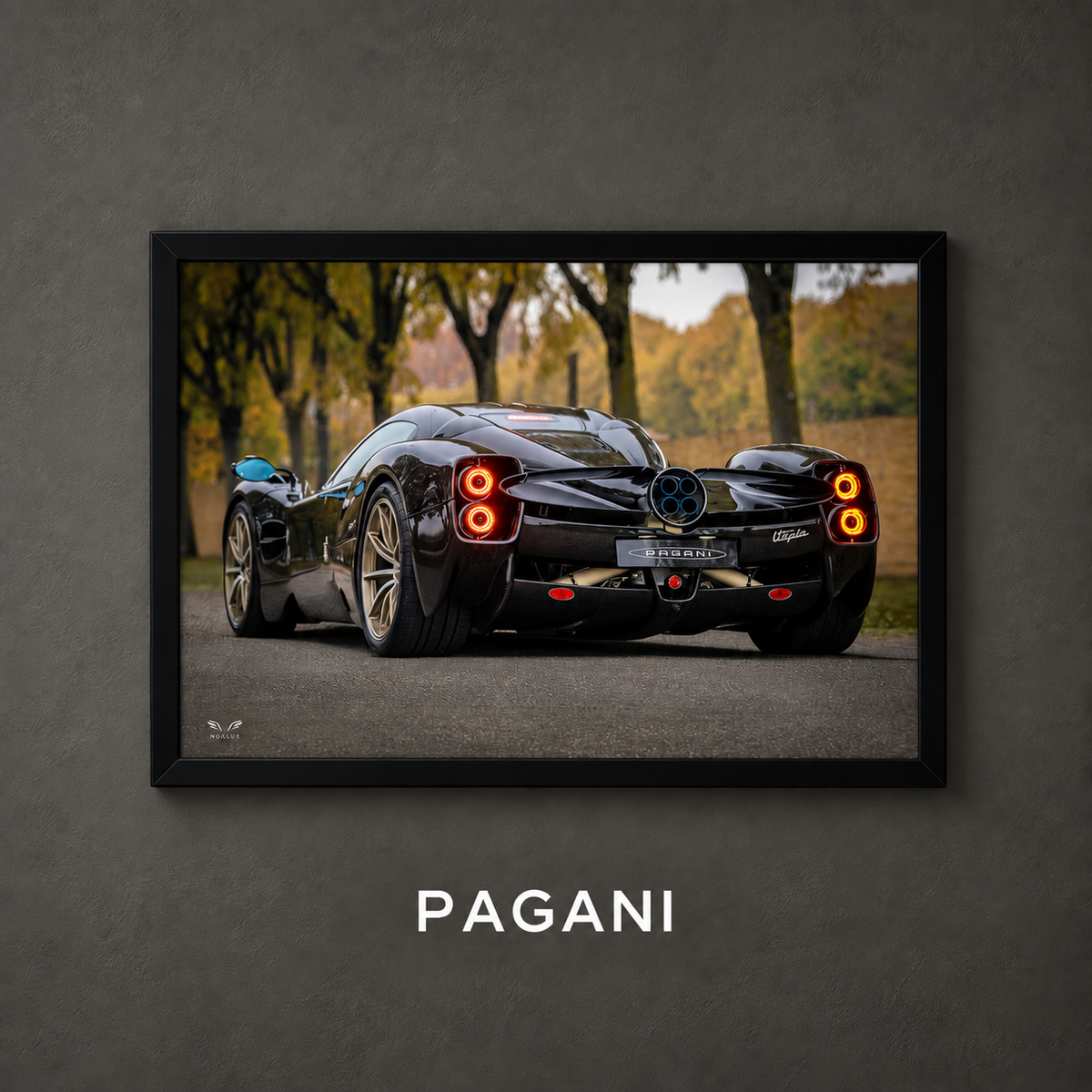 Framed Pagani car poster on a charcoal wall with collection label