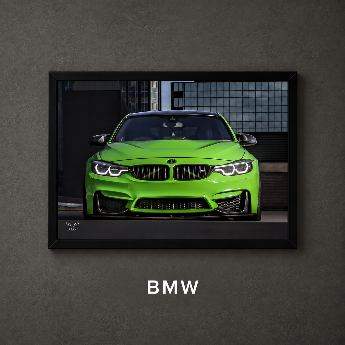 Framed BMW car poster on a charcoal wall with collection label