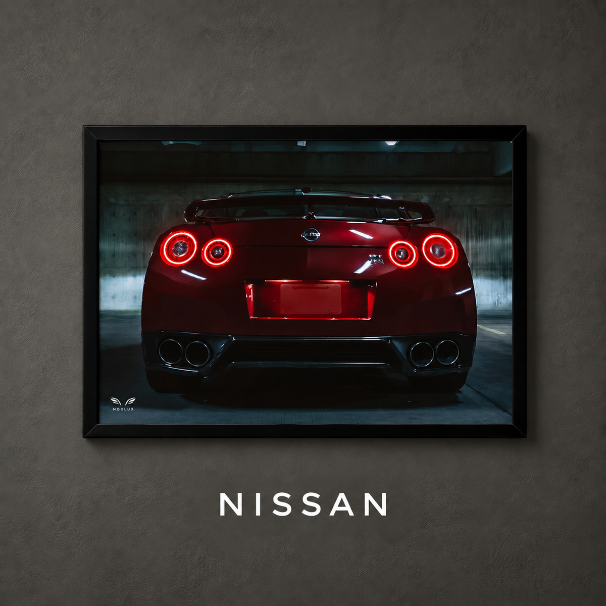 Framed Nissan car poster on a charcoal wall with collection label